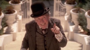 Movie still from “The Day of the Locust” (1975), directed by John Schlesinger – An old man wearing a top hat and a suit; Close Up shot, Low angle