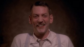 Movie still from “The Day of the Locust” (1975), directed by John Schlesinger – A person wearing a shirt and a tie; Close Up shot, Low angle