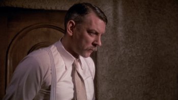 Movie still from “The Day of the Locust” (1975), directed by John Schlesinger – A person wearing a shirt and tie; Close Up shot, Low angle