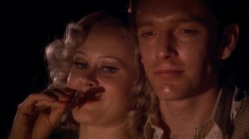 Movie still from “The Day of the Locust” (1975), directed by John Schlesinger – A man and a woman pose for a picture; Close Up shot, Low angle