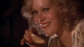 Movie still from “The Day of the Locust” (1975), directed by John Schlesinger – A woman holding a piece of food in her hand; Extreme Close Up shot, Low angle