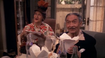 Movie still from “The Day of the Locust” (1975), directed by John Schlesinger – An older man and woman sitting at a dinner table; Medium shot, High angle