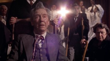 Movie still from “The Day of the Locust” (1975), directed by John Schlesinger – An older man in a suit and tie; Medium shot, Low angle