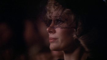 Movie still from “The Day of the Locust” (1975), directed by John Schlesinger – A person wearing a mask; Close Up shot, Over the shoulder angle