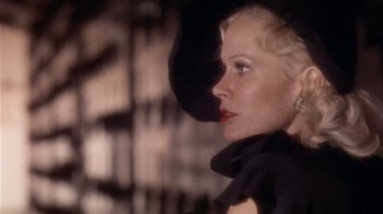 Movie still from “The Day of the Locust” (1975), directed by John Schlesinger – A woman in a black dress and a black hat; Close Up shot, Low angle