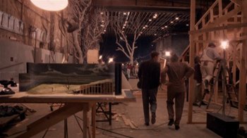 Movie still from “The Day of the Locust” (1975), directed by John Schlesinger – Two men are walking in an art studio; Wide shot, Over the shoulder angle