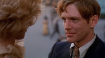 Movie still from “The Day of the Locust” (1975), directed by John Schlesinger – A person wearing a suit and tie; Close Up shot, Over the shoulder angle