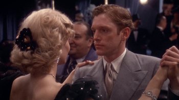 Movie still from “The Day of the Locust” (1975), directed by John Schlesinger – A man and a woman are talking to each other; Medium shot, Over the shoulder angle