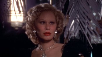 Movie still from “The Day of the Locust” (1975), directed by John Schlesinger – A person wearing a necklace; Close Up shot, Low angle
