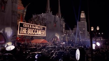 Movie still from “The Day of the Locust” (1975), directed by John Schlesinger – A crowd of cars driving down a street at night; Extreme Wide shot, High angle