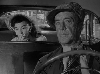 Movie still from “The Day the Earth Stood Still” (1951), directed by Robert Wise – An older man and a young woman sitting in the front seat of a car; Close Up shot, Over the shoulder angle
