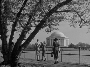 Movie still from “The Day the Earth Stood Still” (1951), directed by Robert Wise – A group of people standing next to each other near a tree; Extreme Wide shot, Low angle