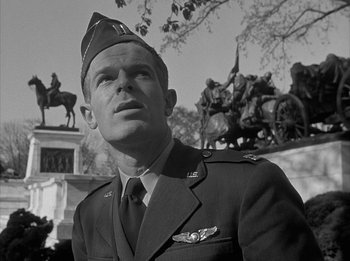 Movie still from “The Day the Earth Stood Still” (1951), directed by Robert Wise – A man in a military uniform standing in front of a statue; Close Up shot, Low angle