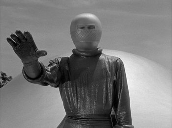 Movie still from “The Day the Earth Stood Still” (1951), directed by Robert Wise – A man in a spacesuit and helmet waving; Medium shot, Low angle