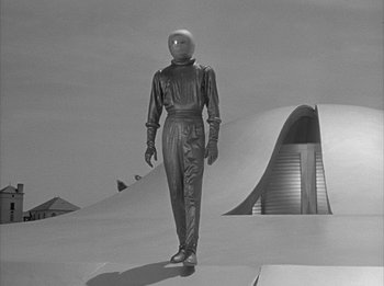 Movie still from “The Day the Earth Stood Still” (1951), directed by Robert Wise – A black and white photo of a person in a suit; Wide shot, Low angle
