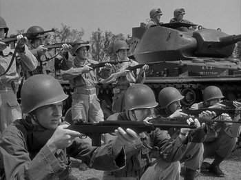Movie still from “The Day the Earth Stood Still” (1951), directed by Robert Wise – A black and white photo of a group of soldiers; Medium shot, Low angle