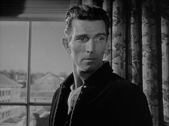 Movie still from “The Day the Earth Stood Still” (1951), directed by Robert Wise – Black and white photograph of a man in front of a window; Close Up shot, Low angle