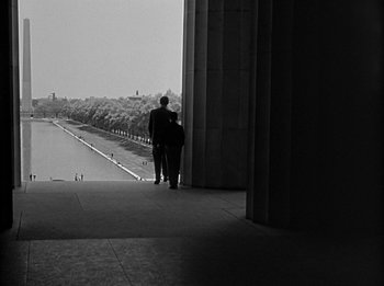 Movie still from “The Day the Earth Stood Still” (1951), directed by Robert Wise – A man and a woman are standing on the steps of the lincoln memorial; Extreme Wide shot, Low angle