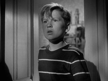 Movie still from “The Day the Earth Stood Still” (1951), directed by Robert Wise – A young boy standing in front of a window; Close Up shot, Low angle