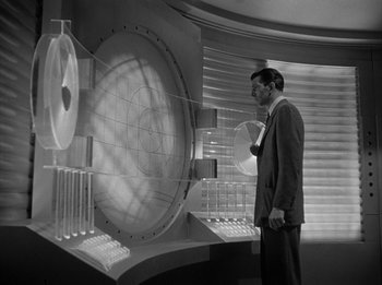 Movie still from “The Day the Earth Stood Still” (1951), directed by Robert Wise – A black and white photo of a man in a suit and tie; Medium shot, Low angle