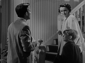 Movie still from “The Day the Earth Stood Still” (1951), directed by Robert Wise – A man and a woman talking to a boy and a girl; Medium shot, Low angle