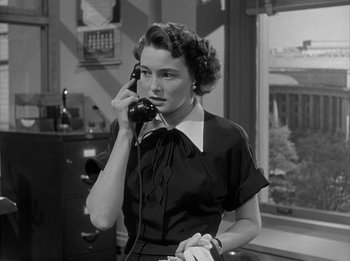 Movie still from “The Day the Earth Stood Still” (1951), directed by Robert Wise – A woman talking on a phone in a room; Medium shot, High angle