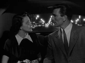 Movie still from “The Day the Earth Stood Still” (1951), directed by Robert Wise – A man and a woman sitting in the back of a car; Medium shot, High angle