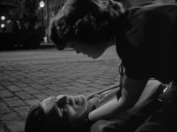 Movie still from “The Day the Earth Stood Still” (1951), directed by Robert Wise – A man laying on the ground next to a woman; Close Up shot, High angle