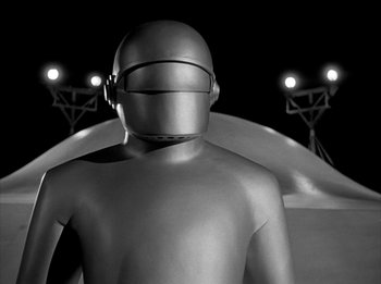Movie still from “The Day the Earth Stood Still” (1951), directed by Robert Wise – A black - and - white photo of a man in a helmet; Wide shot, Low angle
