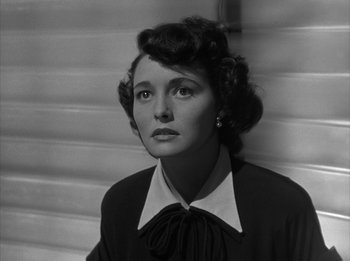 Movie still from “The Day the Earth Stood Still” (1951), directed by Robert Wise – An old black and white photo of a woman; Close Up shot, Low angle