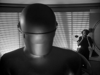 Movie still from “The Day the Earth Stood Still” (1951), directed by Robert Wise – A man is standing in front of a mirror; Medium shot, Low angle