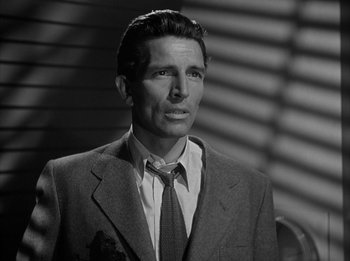 Movie still from “The Day the Earth Stood Still” (1951), directed by Robert Wise – Black and white photograph of a man wearing a suit and tie; Close Up shot, Low angle