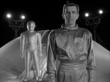 Movie still from “The Day the Earth Stood Still” (1951), directed by Robert Wise – A black - and - white photo of a man and a robot; Medium shot, Low angle