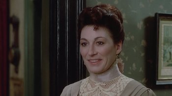 Movie still from “The Dead” (1987), directed by John Huston – A person wearing a dress; Close Up shot, High angle