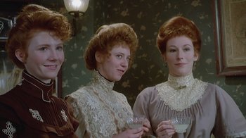 Movie still from “The Dead” (1987), directed by John Huston – A group of three women standing next to each other holding drinks; Close Up shot, High angle