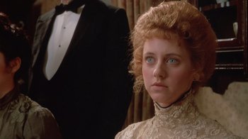 Movie still from “The Dead” (1987), directed by John Huston – A person wearing a suit and tie; Close Up shot, Over the shoulder angle