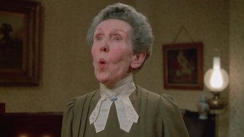 Movie still from “The Dead” (1987), directed by John Huston – An older woman with a disgusted look on her face; Close Up shot, Low angle