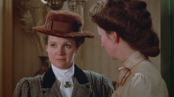 Movie still from “The Dead” (1987), directed by John Huston – A woman wearing a hat looking in the mirror; Close Up shot, Over the shoulder angle