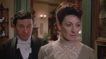 Movie still from “The Dead” (1987), directed by John Huston – A man and a woman dressed in formal wear; Close Up shot, Over the shoulder angle
