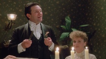 Movie still from “The Dead” (1987), directed by John Huston – A man and a woman sitting in front of candles; Medium shot, Low angle