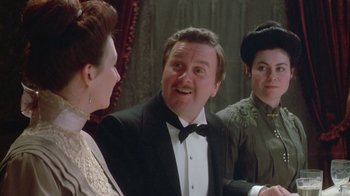 Movie still from “The Dead” (1987), directed by John Huston – Two women and a man in a suit and bow tie; Close Up shot, Over the shoulder angle