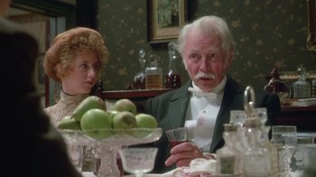 Movie still from “The Dead” (1987), directed by John Huston – An older man and woman sitting at a dinner table; Close Up shot, Over the shoulder angle