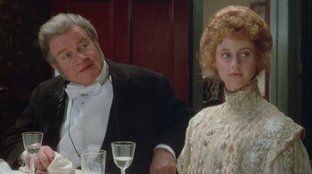 Movie still from “The Dead” (1987), directed by John Huston – An older man and a young woman sitting at a dinner table; Close Up shot, Over the shoulder angle