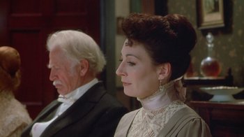 Movie still from “The Dead” (1987), directed by John Huston – An older man and a woman dressed in period clothing; Close Up shot, High angle