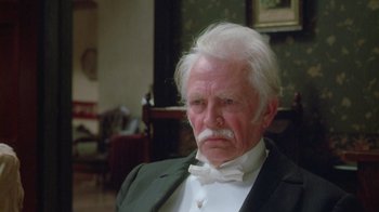 Movie still from “The Dead” (1987), directed by John Huston – An old man with white hair and a white beard; Close Up shot, Low angle