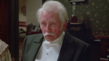 Movie still from “The Dead” (1987), directed by John Huston – An old man with white hair wearing a white bow tie; Close Up shot, Low angle