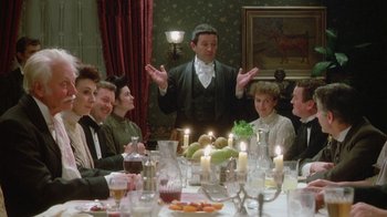 Movie still from “The Dead” (1987), directed by John Huston – A group of people sitting around a dinner table; Medium shot, High angle
