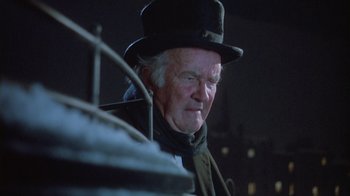 Movie still from “The Dead” (1987), directed by John Huston – An old man wearing a top hat and a coat; Close Up shot, Low angle