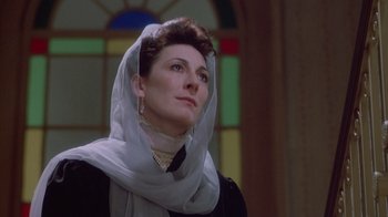 Movie still from “The Dead” (1987), directed by John Huston – A woman wearing a white veil looking upward; Close Up shot, Low angle