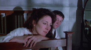 Movie still from “The Dead” (1987), directed by John Huston – A man and a woman sitting next to each other; Close Up shot, Low angle